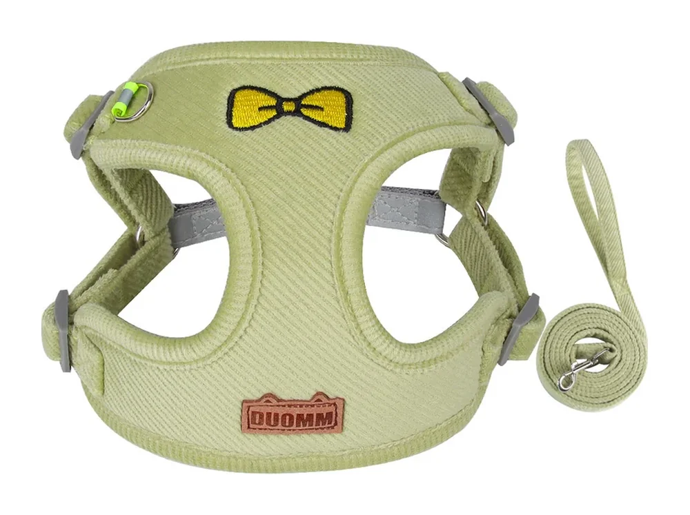 Green fleece vest harness with a bear badge and a matching leash, laid flat
