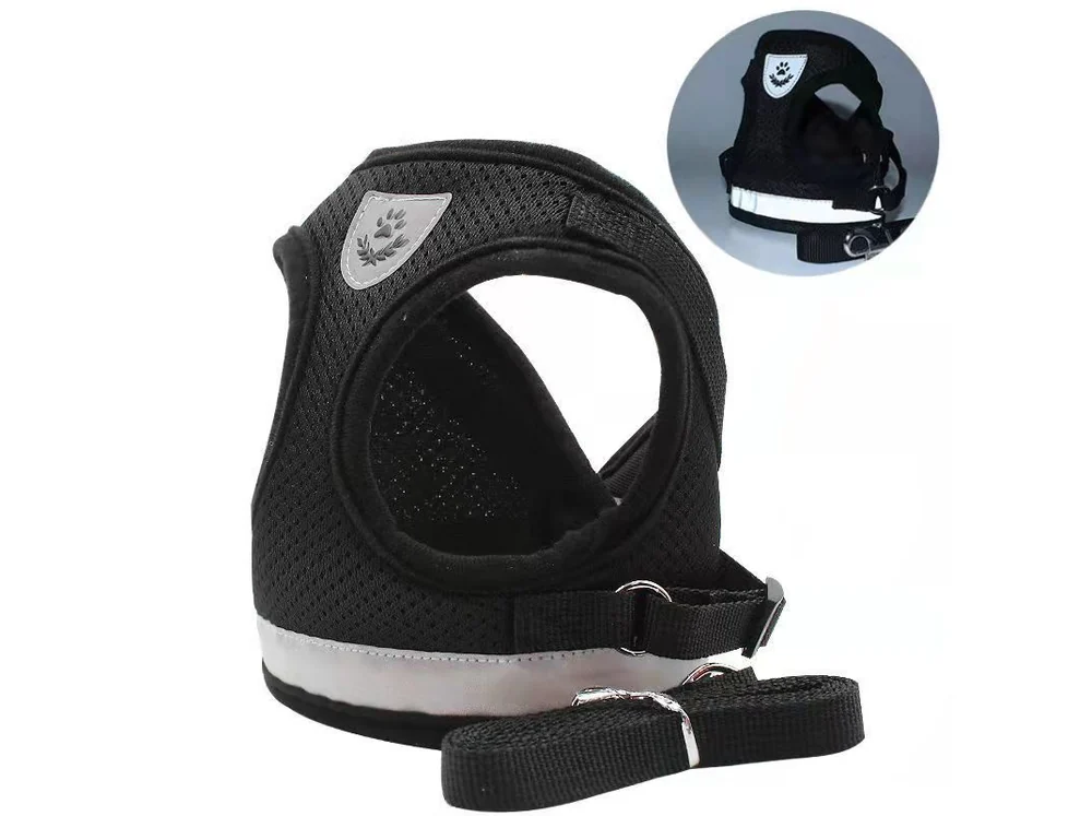 Black air-mesh harness with a reflective band and a matching leash, laid flat